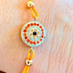 Orange crystal string bracelet evil eye